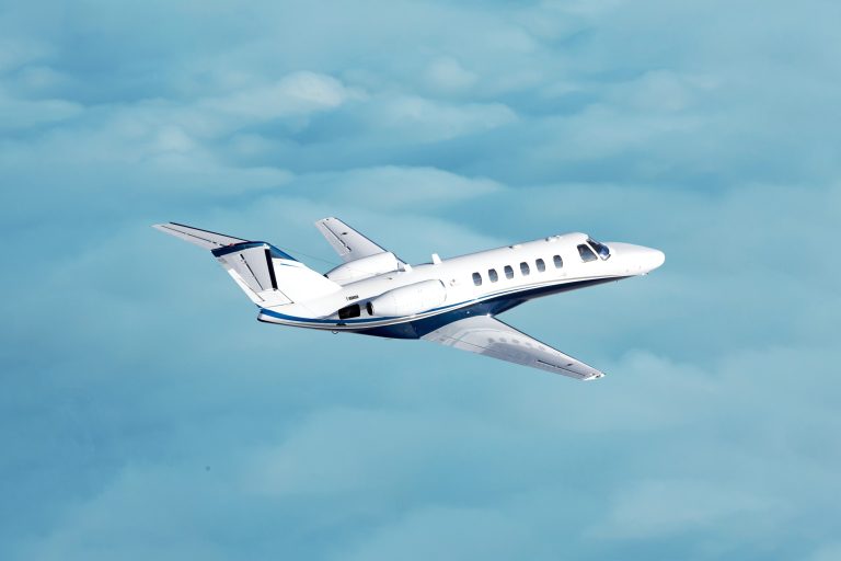 business jet flying through clouds