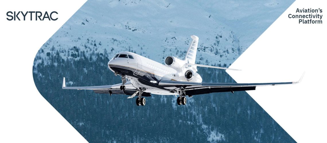 White business jet flying near snowy mountains